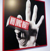 Hand holding block labeled “Who owns what?”