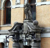 Carved lion seated above entrance to building