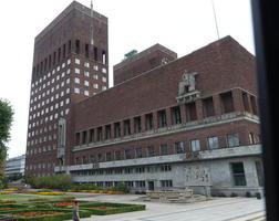 multi-story brick building with sculpture of horse and rider at second floor