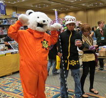 Man in orange jumpsuit and polar bear head costume