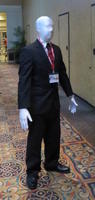 Man in all-white body suit wearing business suit.