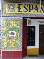 Geometric design in blue on yellow tiles on a storefront