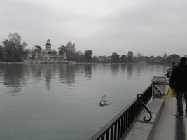 Long view of monument across a lake, showing lake and “downstream.”