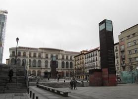 Courtyard outside museum; large brown metal rectangular sculpture at right