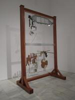 Glass panel in wood frame; blue glass on top, brown glass in form of musical instruments on bottom.