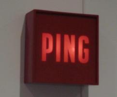 Brown box built like a lighted EXIT sign, but it flashes the word PING.