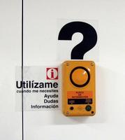 Subway information call box whose button forms the dot in a question mark.