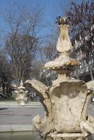 Fountain in foreground, similar one in background