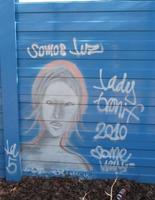 Graffitti of a woman with words “We are light”