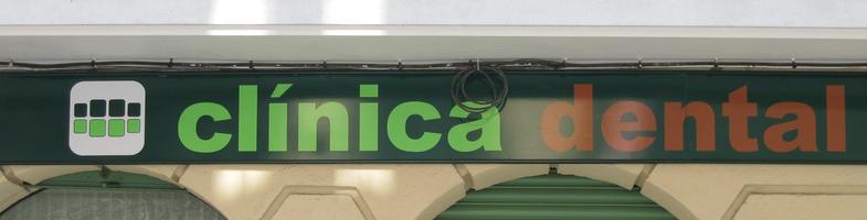 Sign for dental clinic with stylized teeth as logo