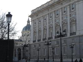 Facade of Royal Palace in foreground; church dome in background