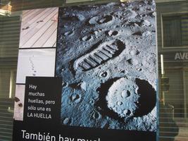 Sign showing footprints at left and lunar footprint at right. Text: “There are many footprints, but only one is THE FOOTPRINT.”