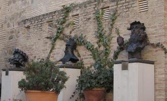 Three abstract sculptures of heads