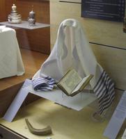 Talis shaped as if being worn, above siddur and shofar