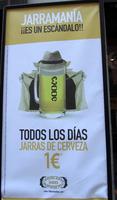 Advert for beer, showing a beer mug wearing hat and raincoat exposing itself