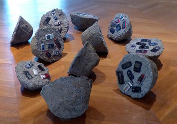 cell phones embedded in rock