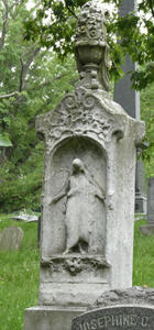 large marker with sculpture of vase of flowers at top