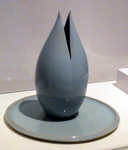 Blue ceramic jar in shape of opening flower bud