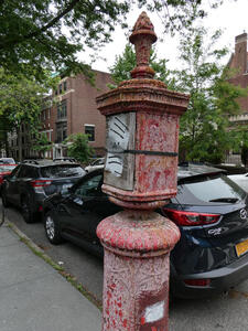 Faded red-painted post on corner