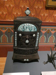 Small desk-size cabinet with orante carving of small children/cherubs