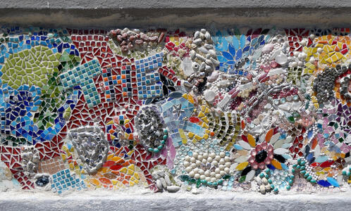multicolor abstract background mosaic with words “Ṭhe Door” in foreground.