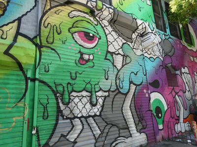 One-eyed green smiling monster