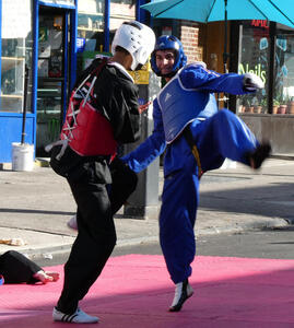 Two teenagers doing a tae kwon do bout