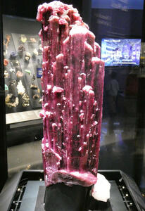 Large red mineral sample with small outcroppings