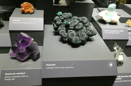 Orange mimetite, purple amethyst, circular green malachite