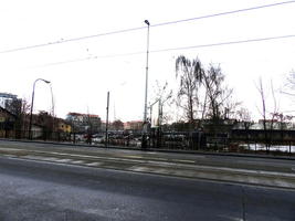View of old buildings and parking lot across street from hotel.