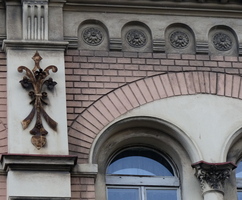 Relief work resembling a fleur de lis