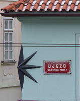 Star-shaped relief around the corner of a building's second floor