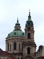 Church clock tower in foreground, dome in background