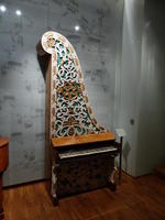 Piano with string area mounted vertically instead of horizontally