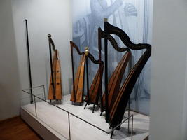 Collection of harps from primitive to modern-looking