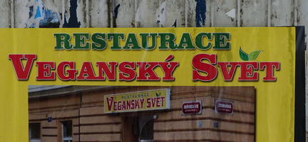 Ad for restaurant Veganský Svět, with leaves for the hacek