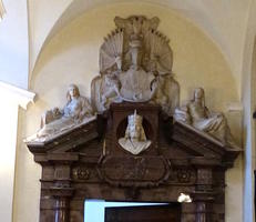 Relief carvings and statuary above a door in clock tower building