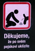 Sign telling people to clean up after their dogs; shows dog defecating