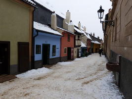 View of Golden Lane; building fronts are painted yellow, blue, and red