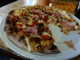 Pizza with ground beef, ham, red pepper, and onion
