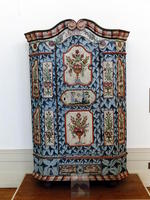 Wooden cabinet painted blue, with flower vases