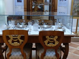 Wooden chairs with gold lyres on back