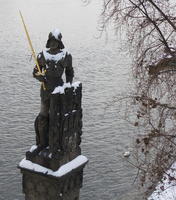 Statue of man in helmet with gold sword