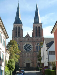 Double-spired brown brick church