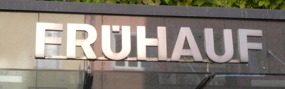 Sign reading FRÜHAUF with only one dot for the umlaut inside the first U.
