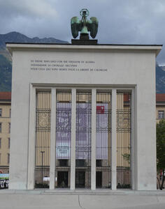 Rectangular “arch” with bronze eagle at top. Text in English, Russian, and French: To those who died for the freedom of Austria