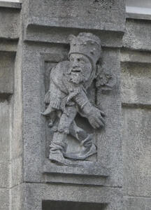 Stone carving of gnome-like figure. He is looking to the left.