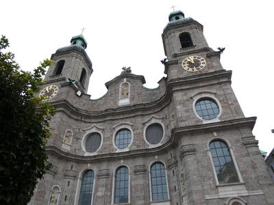 Church towers on either side of main building, each with a clock