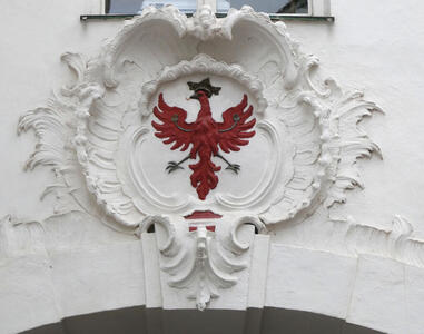 Ornate carving; in center, a heraldic eagle painted red