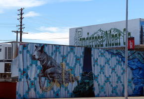 Cow and train painted on facade of a meat company